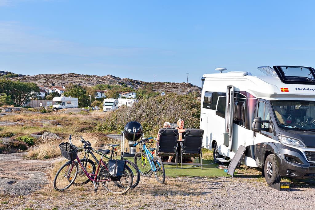 Familie genießt ein entspanntes Camping-Abenteuer im Wald. First Camp Solvik - Kungshamn 